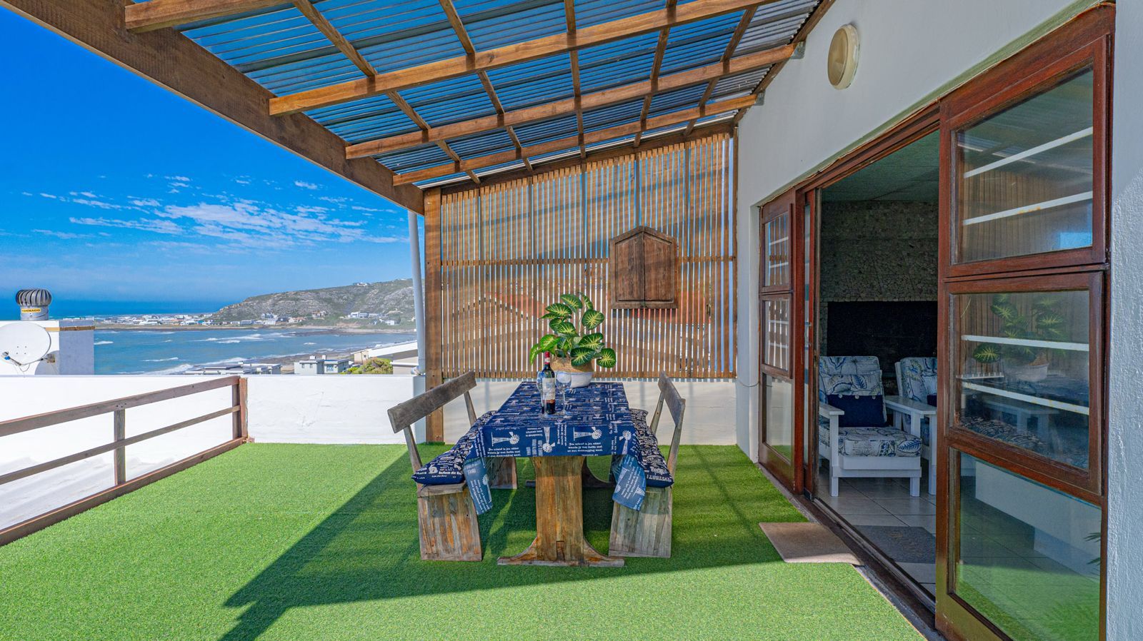 Blue Whale covered balcony with outdoor table and ocean view