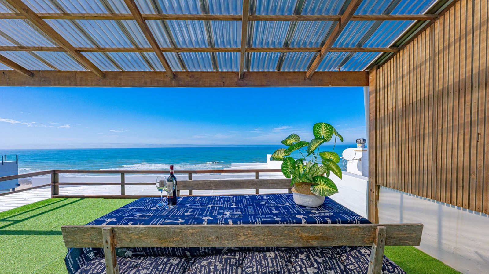 Blue Whale covered balcony dining table with ocean view